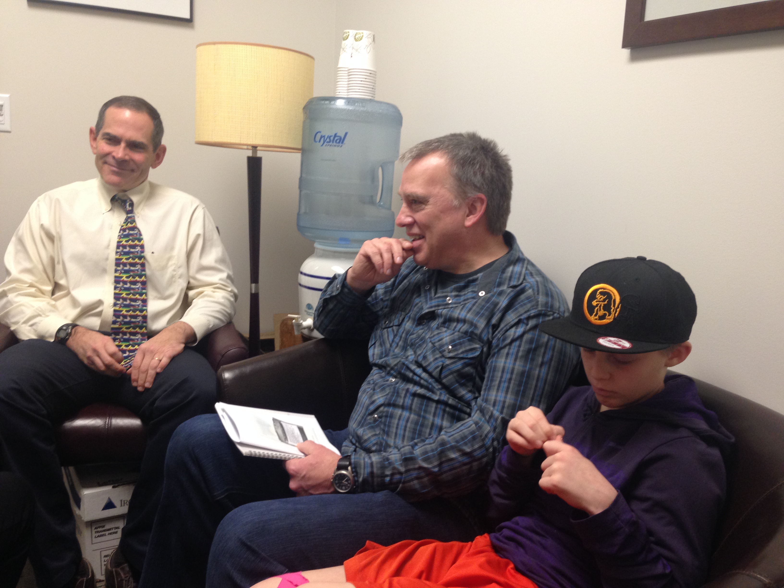 caption: Dr. Stephen Tilles, the principle investigator for the peanut patch study in Seattle, with David Baty and his son Spencer, who suffers from a peanut allergy.