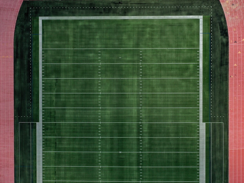 caption: An aerial view of an empty football field at Towson University in Towson, Md. Many colleges rely on summer camps for additional revenue during the summer.