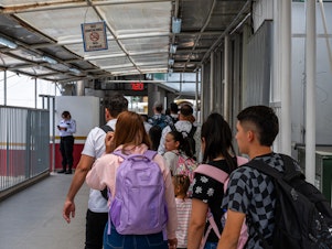 caption: Migrants walk to the Dennis DeConcini Port of Entry for a CBP One meeting in Nogales, Arizona on Friday, June 7, 2024.