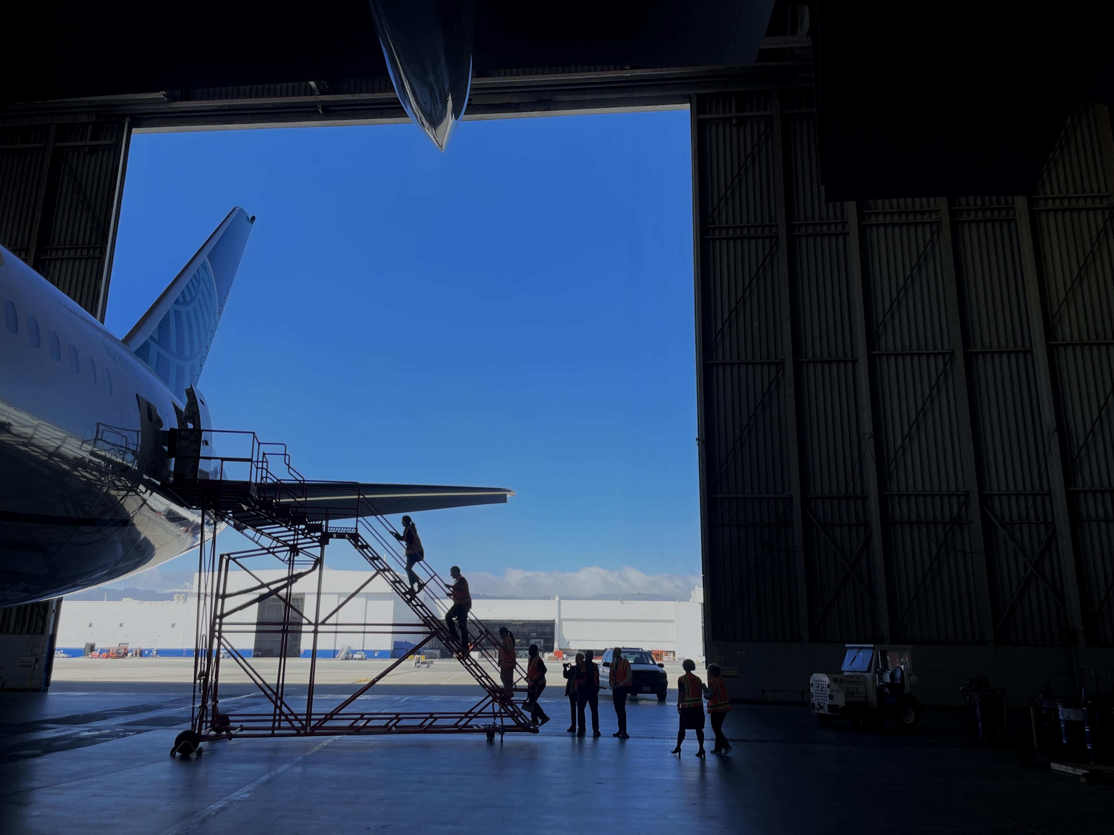 caption: Participants in the Fear of Flying Clinic walk up the boarding stairs and into a 787 as part of a four-day course to help ease their anxiety around air travel. Getting exposed to the sights and sounds of airplanes is one piece of that training.