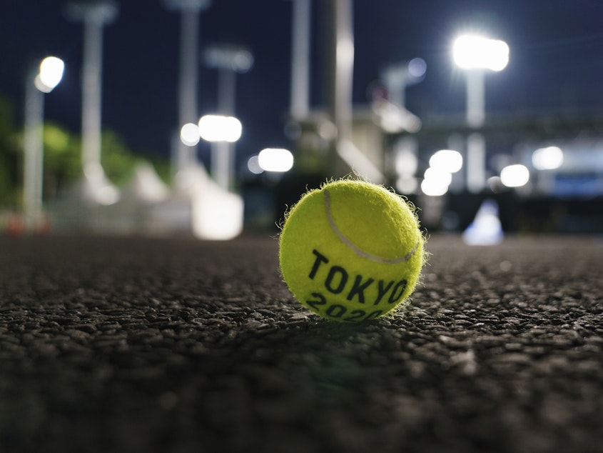 caption: A ball sits outside a court at the Ariake Tennis Park during practice sessions at the Tokyo Olympics on Tuesday.