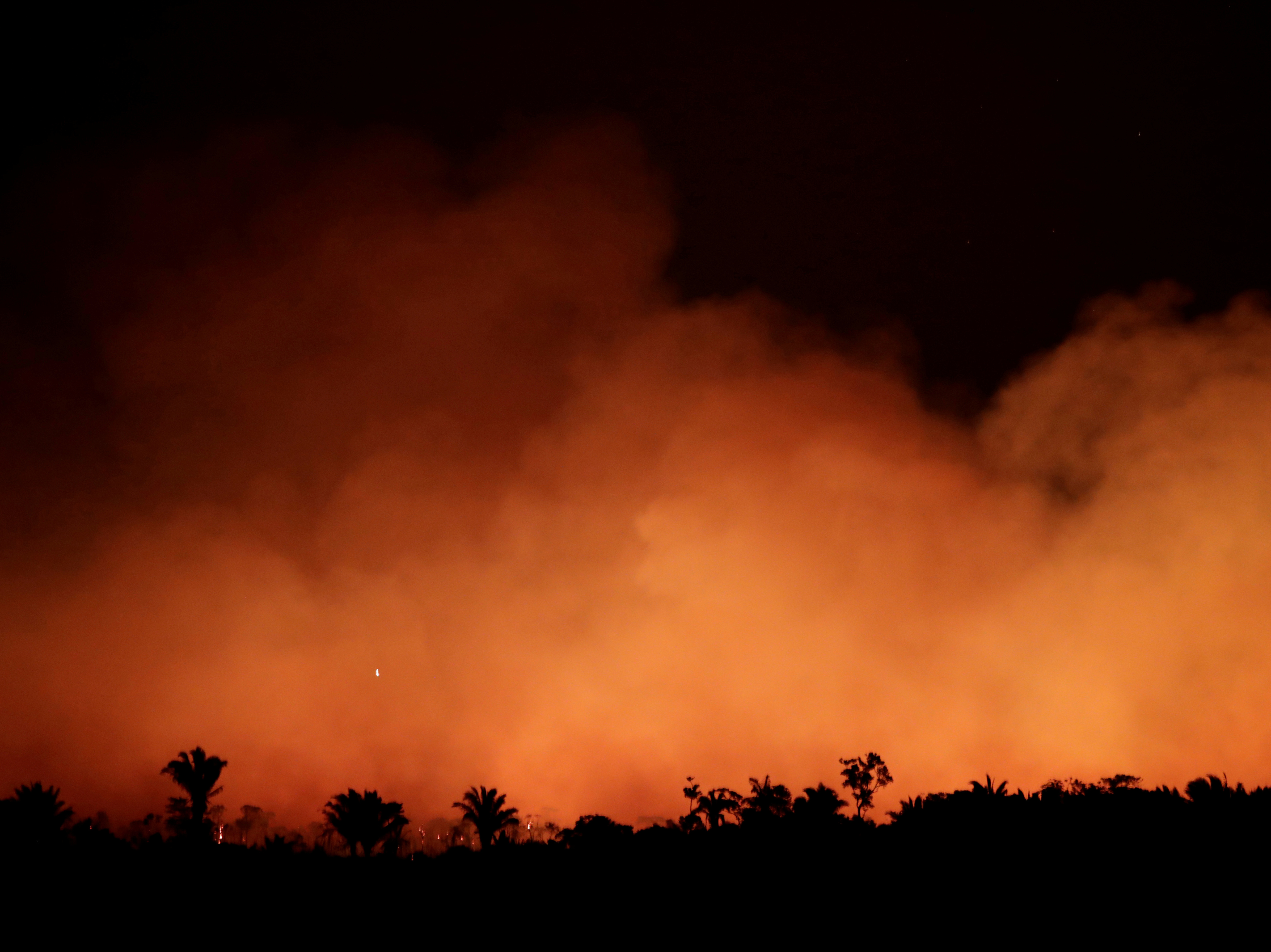 caption: Smoke billows during a fire in an area of the Amazon rainforest near Humaita, Brazil, on Aug. 17.