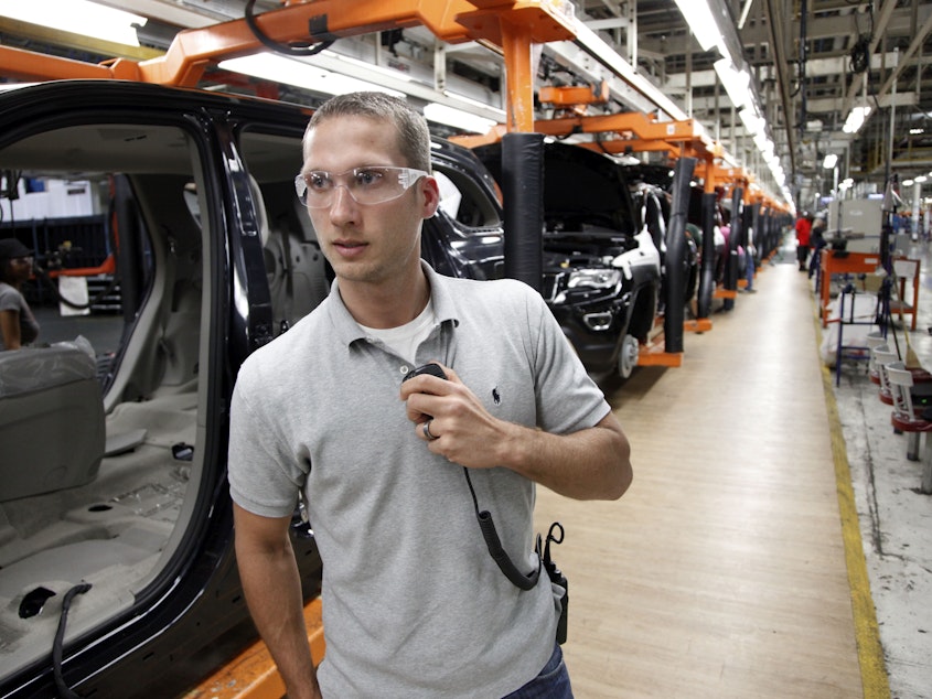 caption: In this Wednesday, May 8, 2013 photo, Jeff Caldwell, 29, a chassis assembly line supervisor, monitors the assembly line at the Chrysler Jefferson North Assembly plant in Detroit.