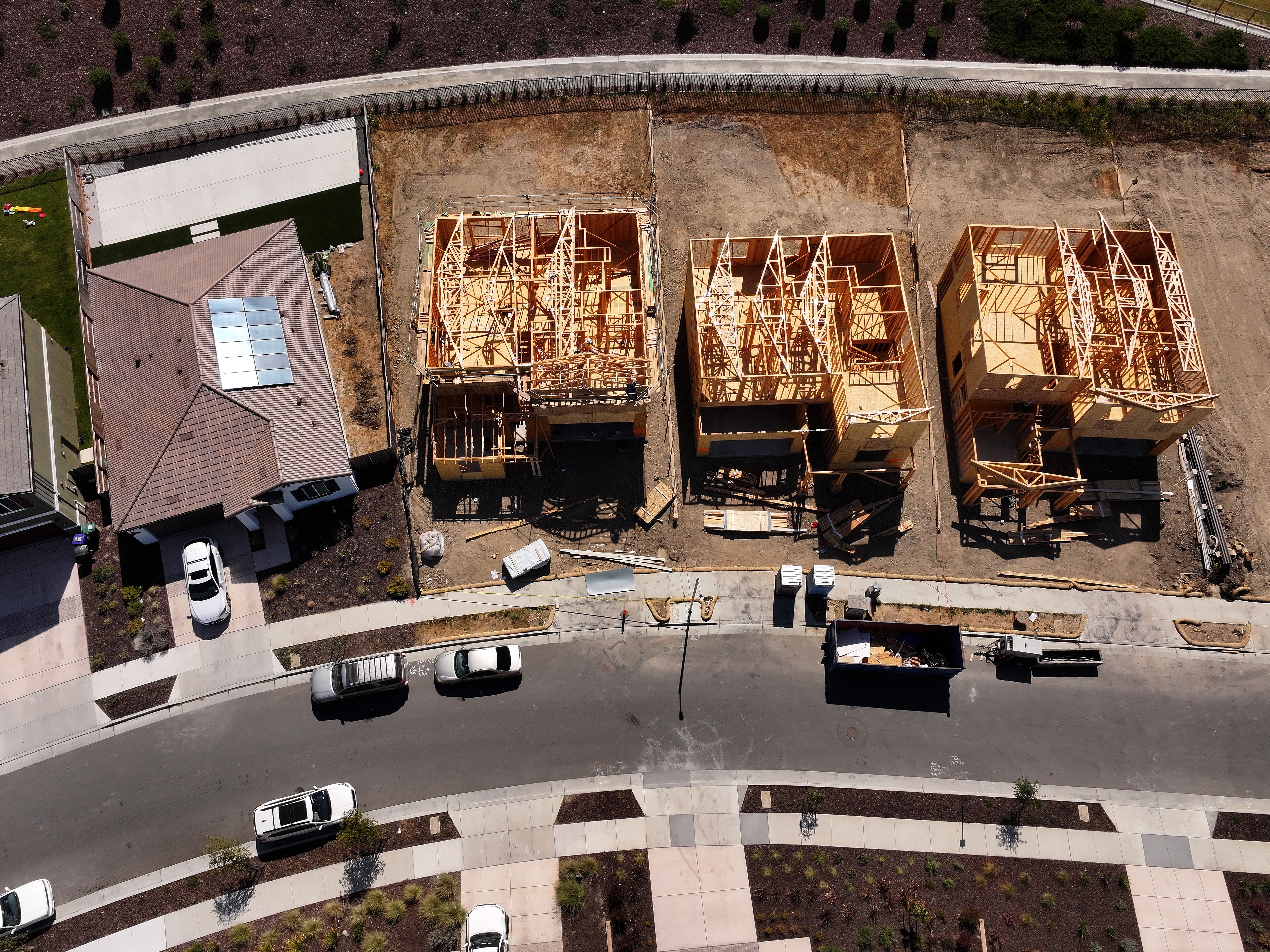 caption: Homes are under construction at a new housing development in Richmond, Calif., on July 1, 2025.