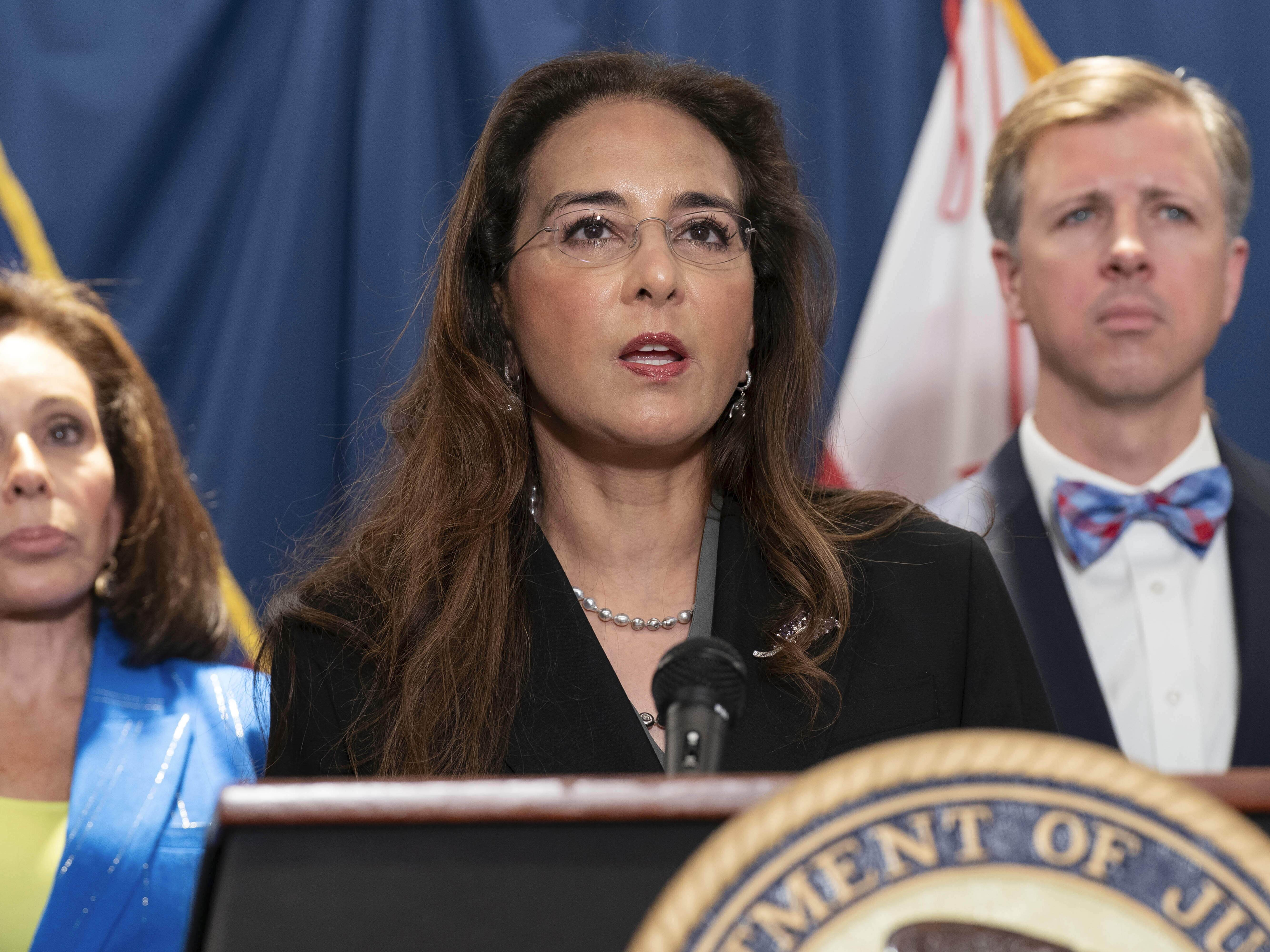 caption: Harmeet Dhillon, head of the Justice Department's Civil Rights Division, speaks during a news conference on Aug. 7.