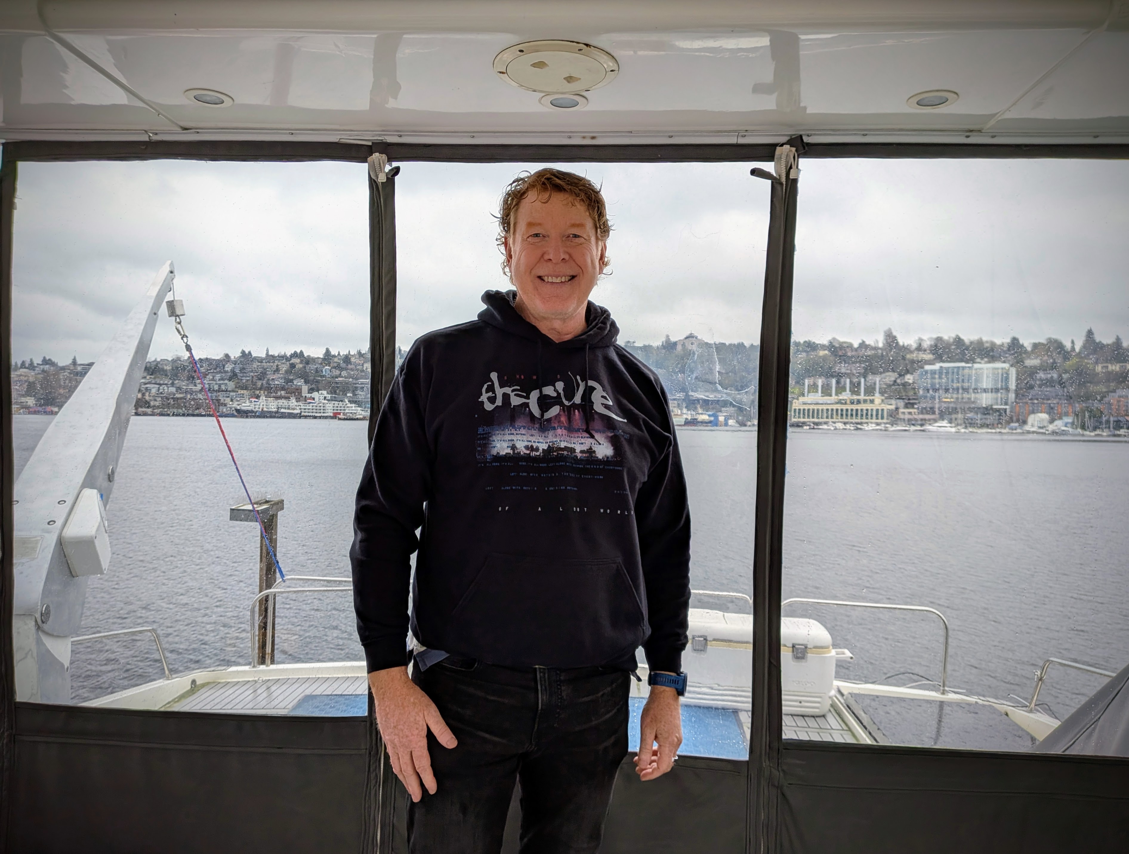 caption: Greg Holloway gives a tour of the luxury yacht he owns and charters out to customers with Seattle's Lake Union in the background. 