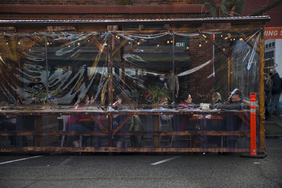 caption: People dine in an outdoor seating area at La Carta De Oaxaca on Monday, March 22, 2021, along Ballard Avenue Northwest in Seattle. Beginning Monday, restaurants, retailers, and fitness centers can open with up to 50% capacity as Washington's 39 counties move into the third phase of Gov. Jay Inslee's reopening plan.