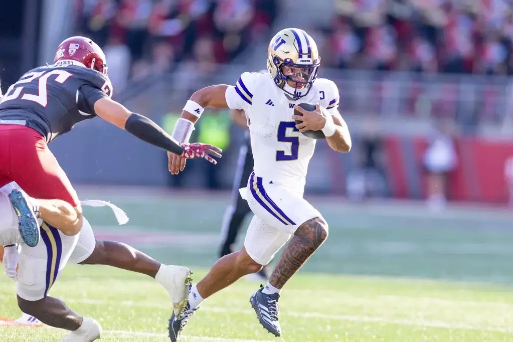 caption: University of Washington Huskies quarterback Demond Williams Jr. plays against Washington State University in the Apple Cup on September 20, 2025. 