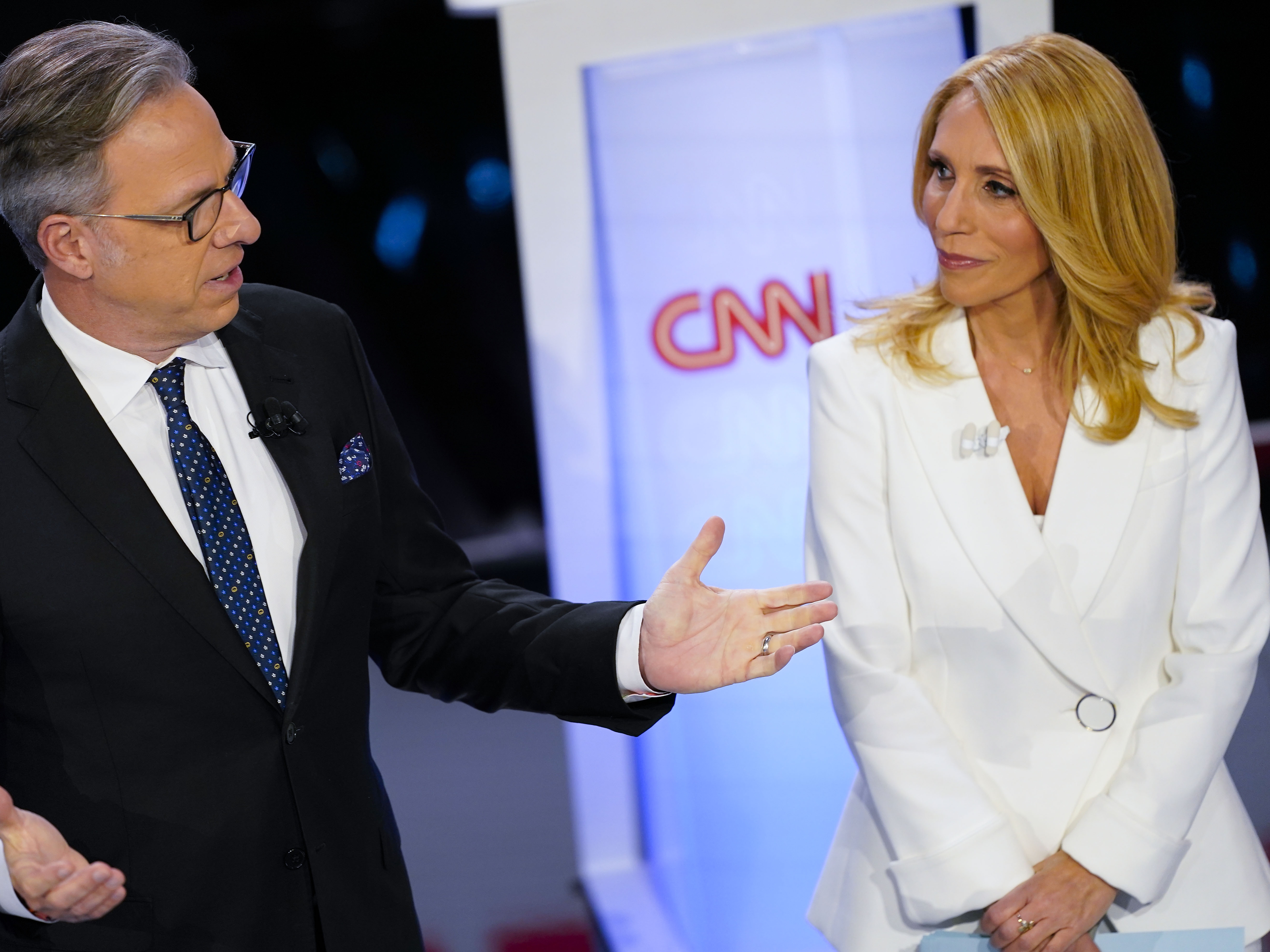 caption: CNN anchors Jake Tapper and Dana Bash speaking to members of the audience before the start of the CNN Republican presidential debate in Des Moines, Iowa, Jan. 10, 2024.