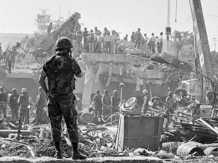 caption: In October 1983, rescuers probe the wreckage of the U.S. Marine command building near the Beirut airport, a day after a terrorist attack killed 241 U.S. service members.
