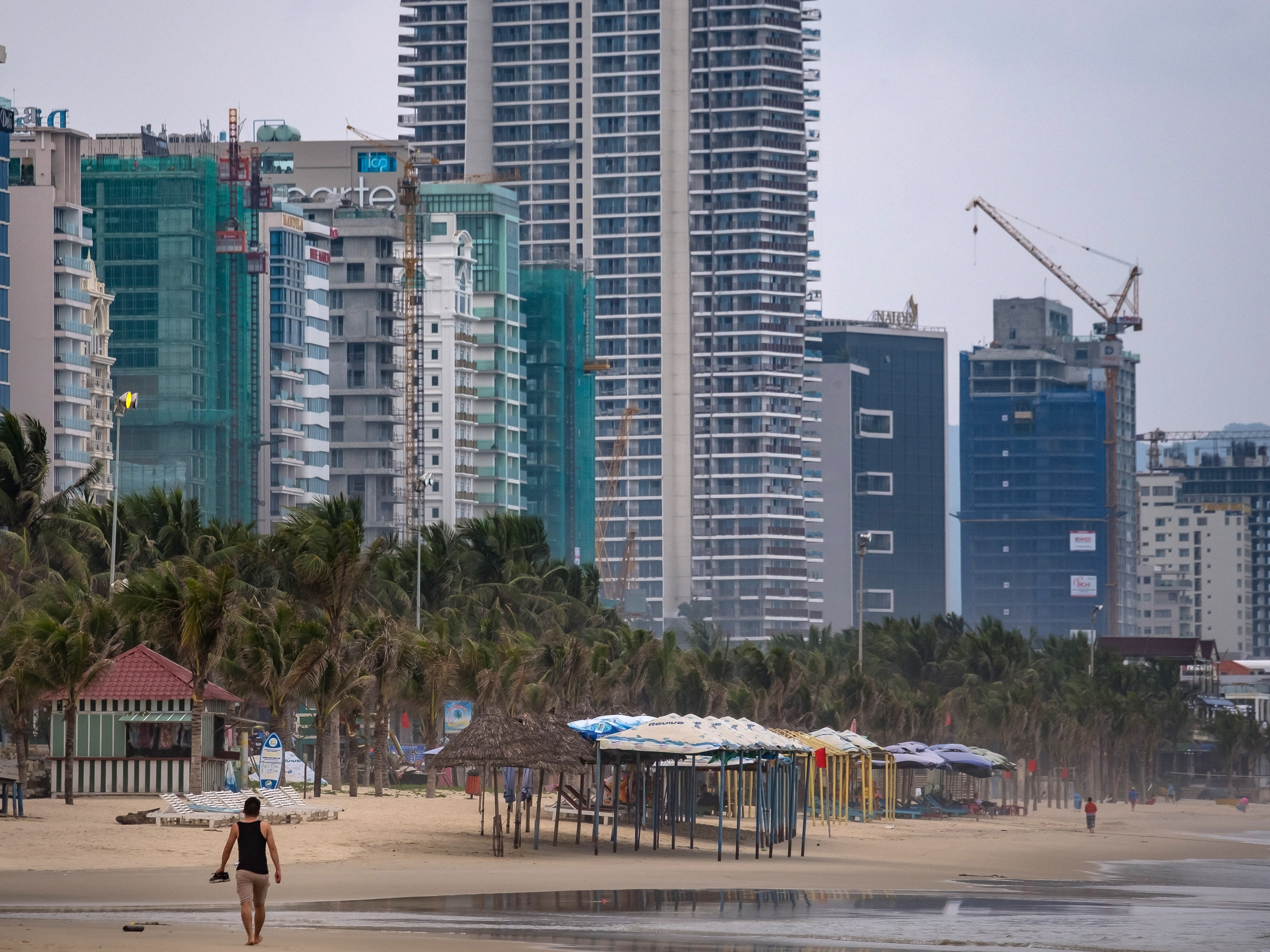 caption: A view of My Khe beach in 2019 in Da Nang, Vietnam. Some Americans who moved to Vietnam or Thailand say they now have less stress and can afford more than they could in the U.S.