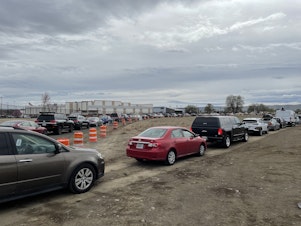 caption: Hundreds of cars wait in line at the FEMA mass vaccination site at the Yakima State Fair Park on April 4, 2021. 