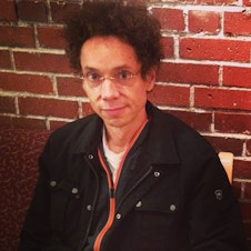 caption: Writer Malcolm Gladwell waits in KUOW's green room before an interview with The Record's Ross Reynold's.