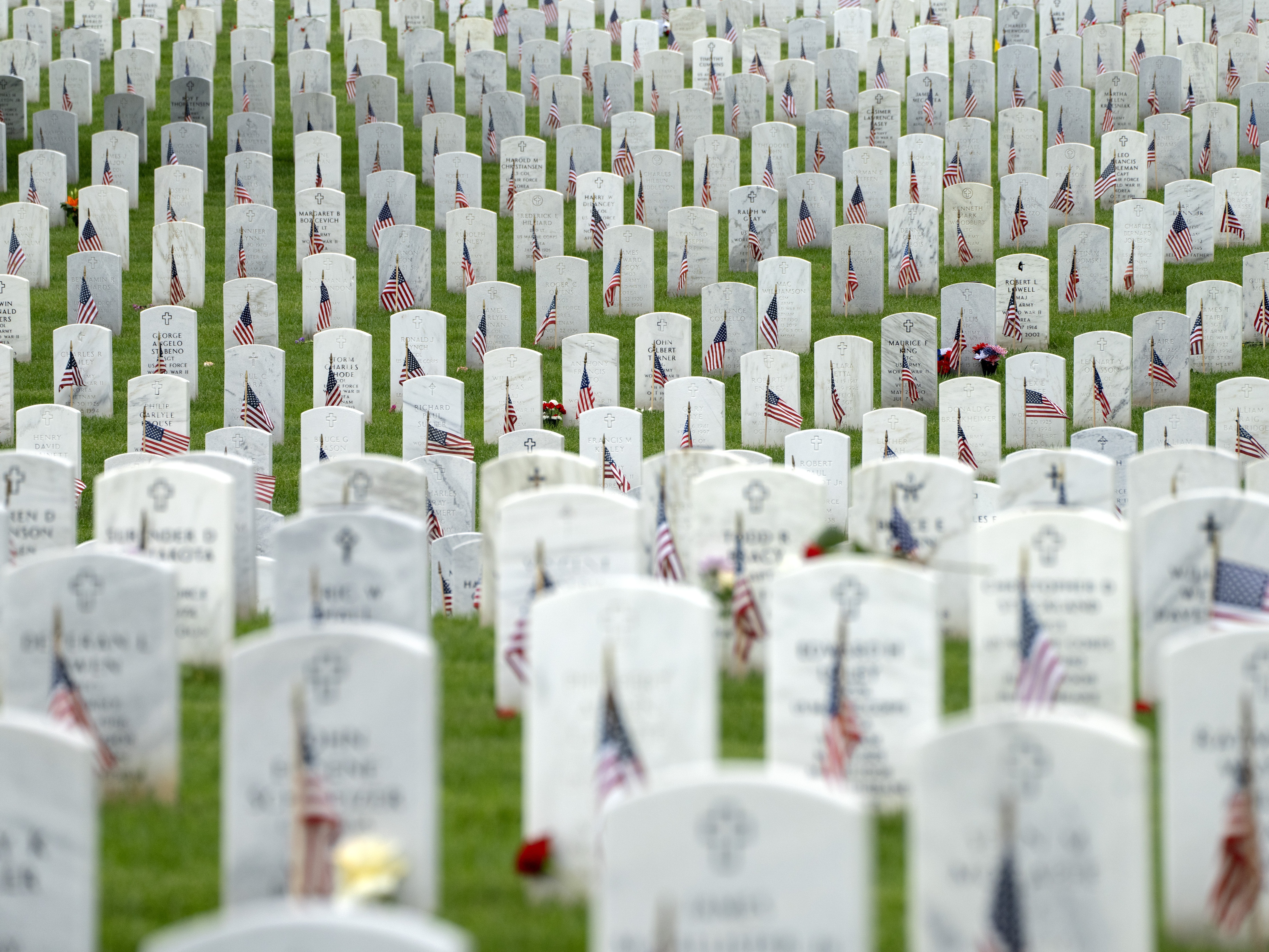 caption: Graves with flags for Memorial Day are seen in Section 60 of Arlington National Cemetery, in Arlington, Va., Monday, May 27, 2024.