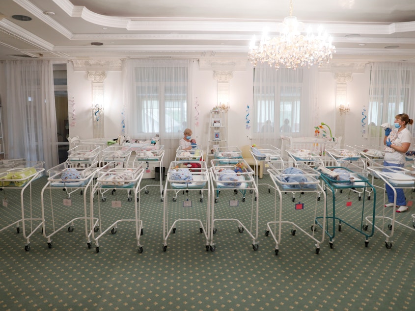 caption: Nurses and newborns in Hotel Venice, a facility owned by BioTexCom clinic in Kyiv, Ukraine, on Thursday. Dozens of babies born to surrogate mothers are stranded in Ukraine as the coronavirus restrictions prevent  foreign parents from collecting them.