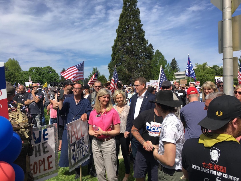 caption: Republican state Reps. Vicki Kraft, in pink, and Matt Shea, in the blue blazer, were among the speakers at Saturday's "Hazardous Liberty" event.