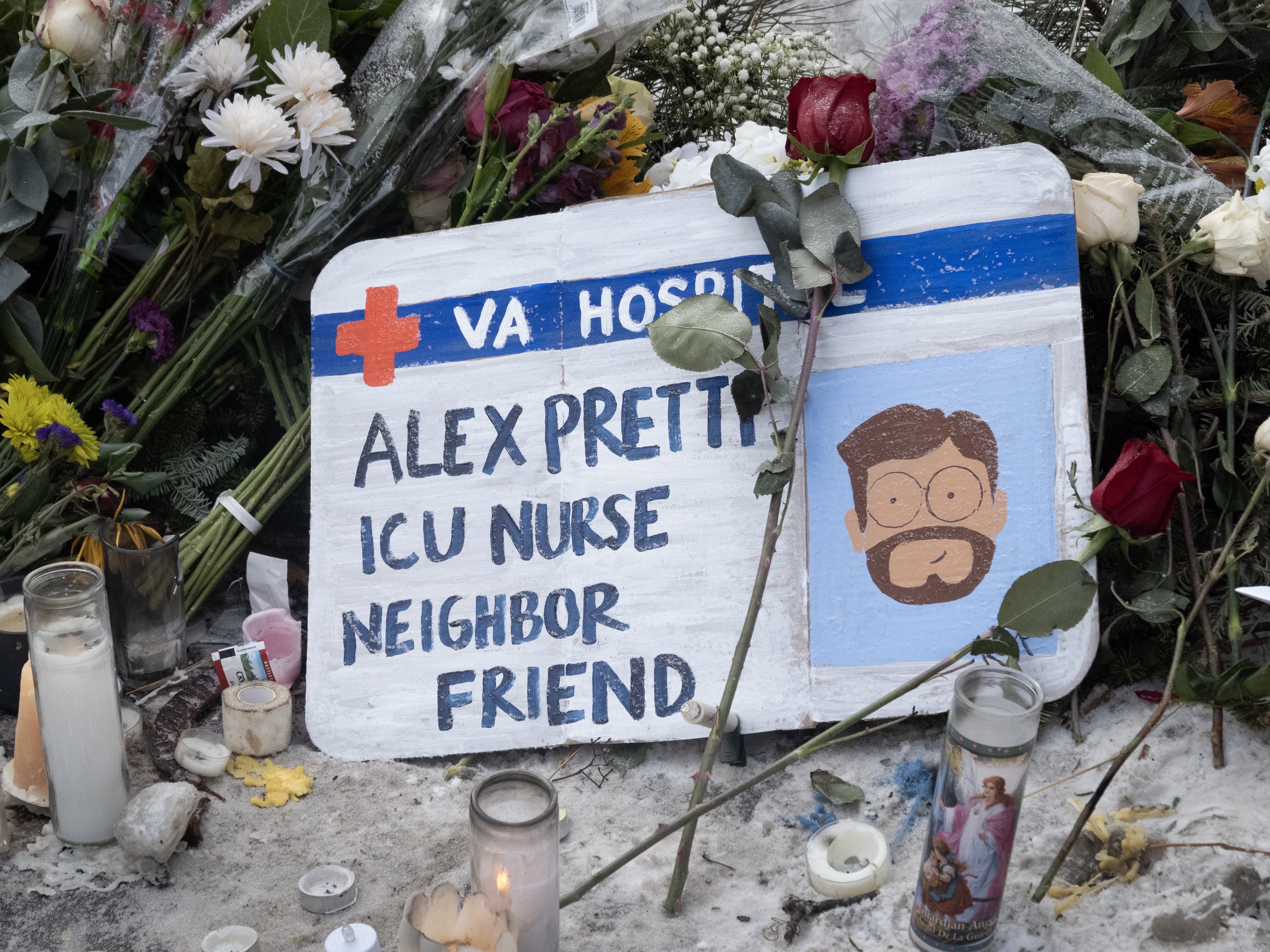 caption: Flowers and candles make up a memorial to Alex Pretti on Jan. 25 in Minneapolis. Pretti, an ICU nurse at a VA medical center, was killed Saturday after being shot multiple times during a brief altercation with border patrol agents in the Eat Street Crossing district of Minneapolis.