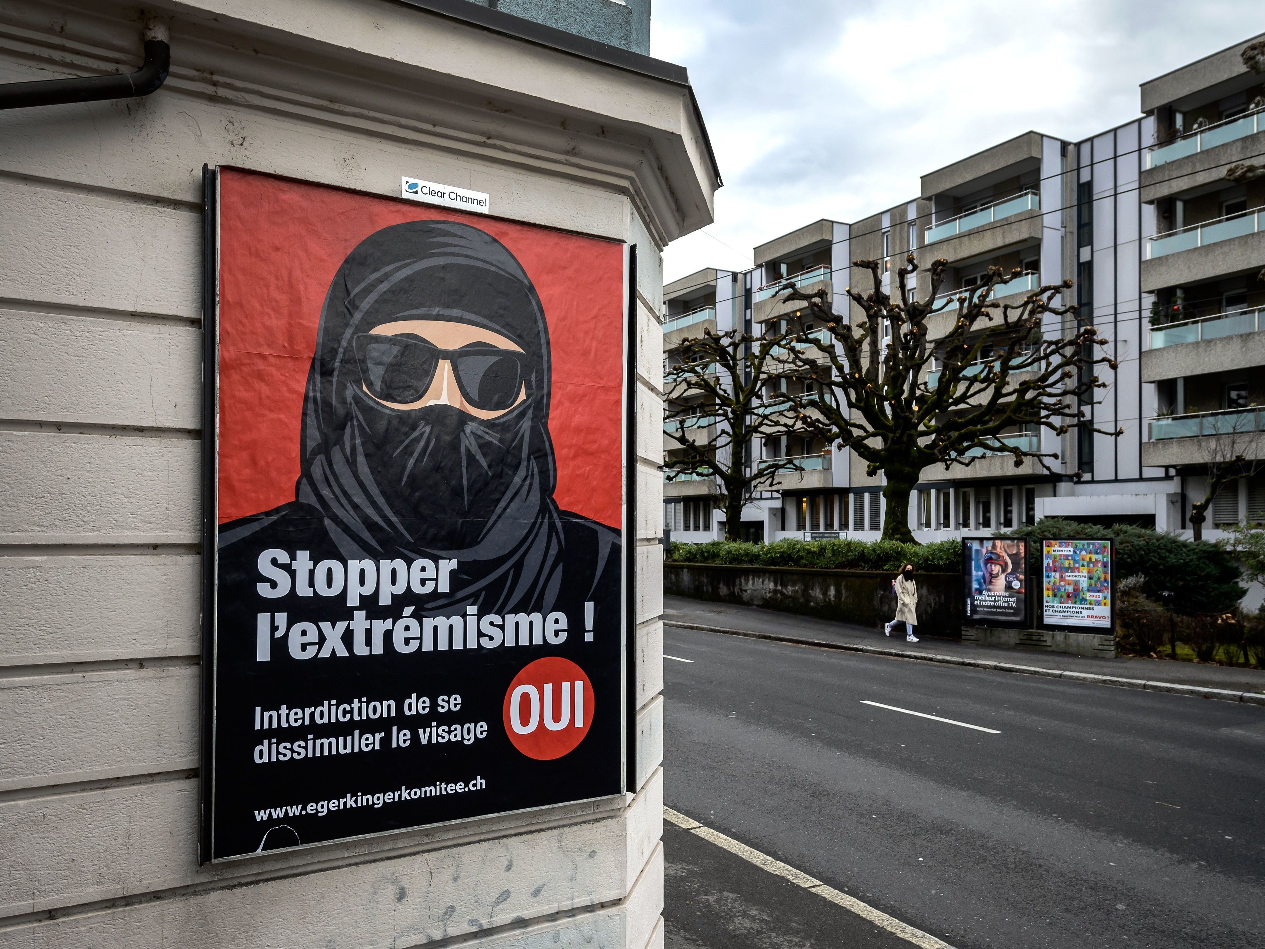 caption: A poster in Lausanne, Switzerland, reads "Stop extremism!" The Swiss passed a new ban on facial coverings in public in a narrow 51.2% majority vote Sunday.