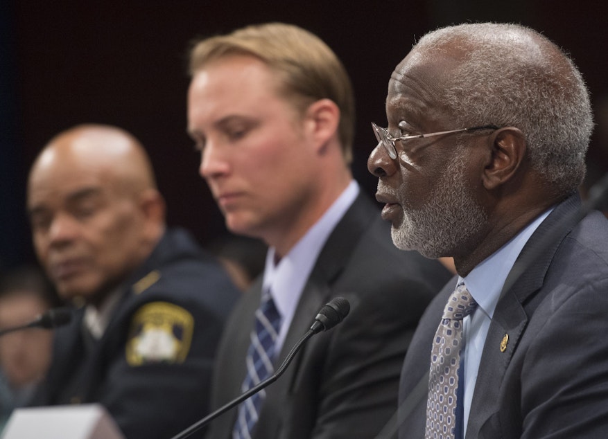 caption: Police Chief John Dixon (L), of Petersburg, Virginia, Chris Kitaeff (C), board member of Arizonans for Gun Safety and a gun dealer, and former US Surgeon General David Satcher (R), speak during a forum on gun safety reform on Capitol Hill in Washington, DC, December 8, 2015. (SAUL LOEB/AFP via Getty Images)