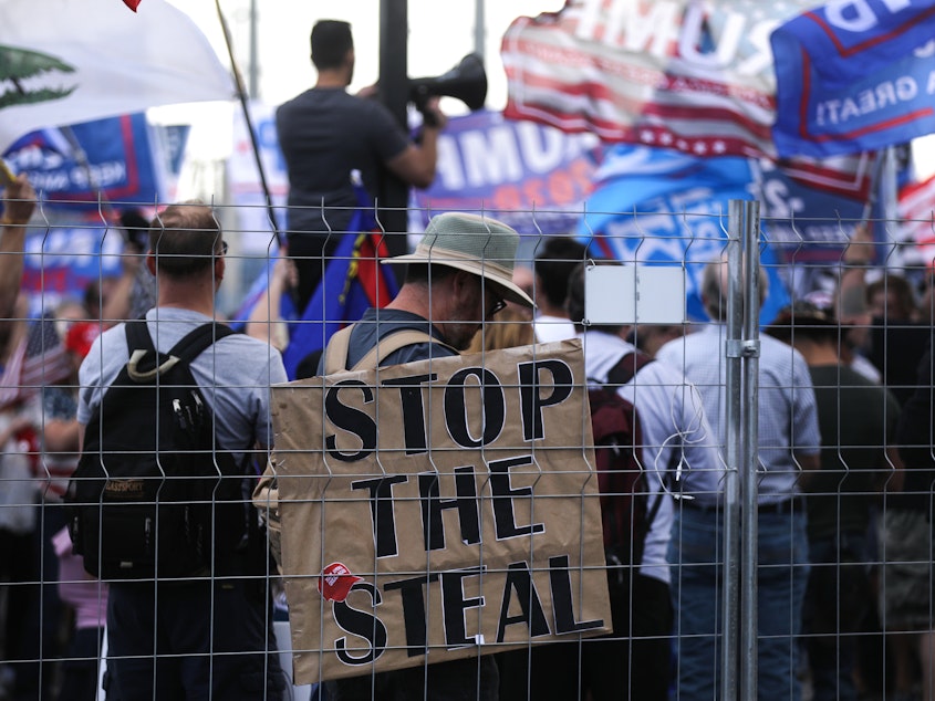 caption: Supporters of President Trump demonstrate at a "Stop the Steal" rally in front of the Maricopa County Elections Department office in Phoenix on Saturday. Domestic terrorism analysts warn that a prolonged fight and Trump's statements about the vote only fuel polarization.