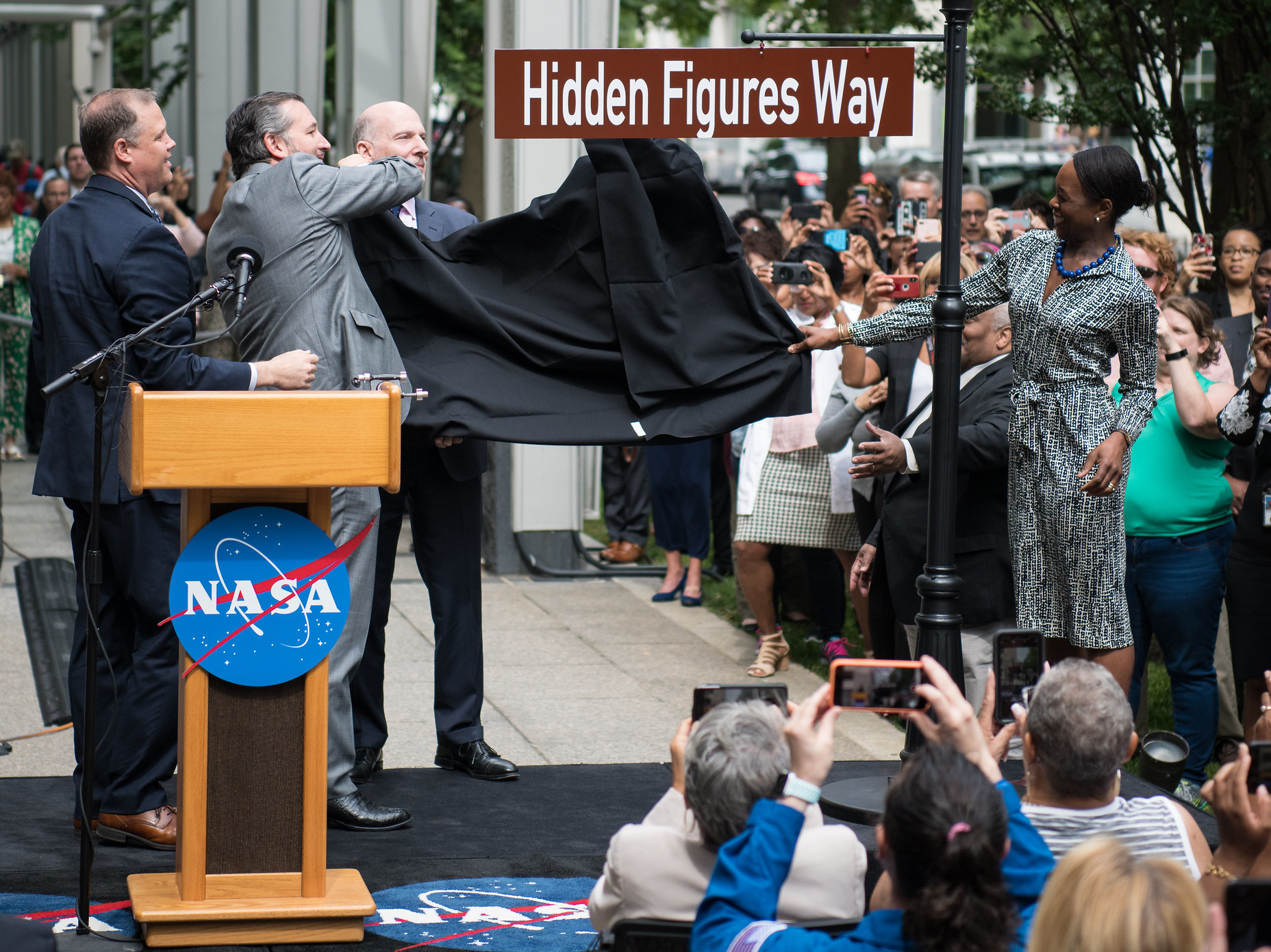 caption: NASA Administrator Jim Bridenstine (from left), Sen. Ted Cruz, D.C. Council Chairman Phil Mendelson and Margot Lee Shetterly, author of the book <em>Hidden Figures,</em> unveil the Hidden Figures Way street sign at a dedication ceremony on Wednesday in Washington, D.C.