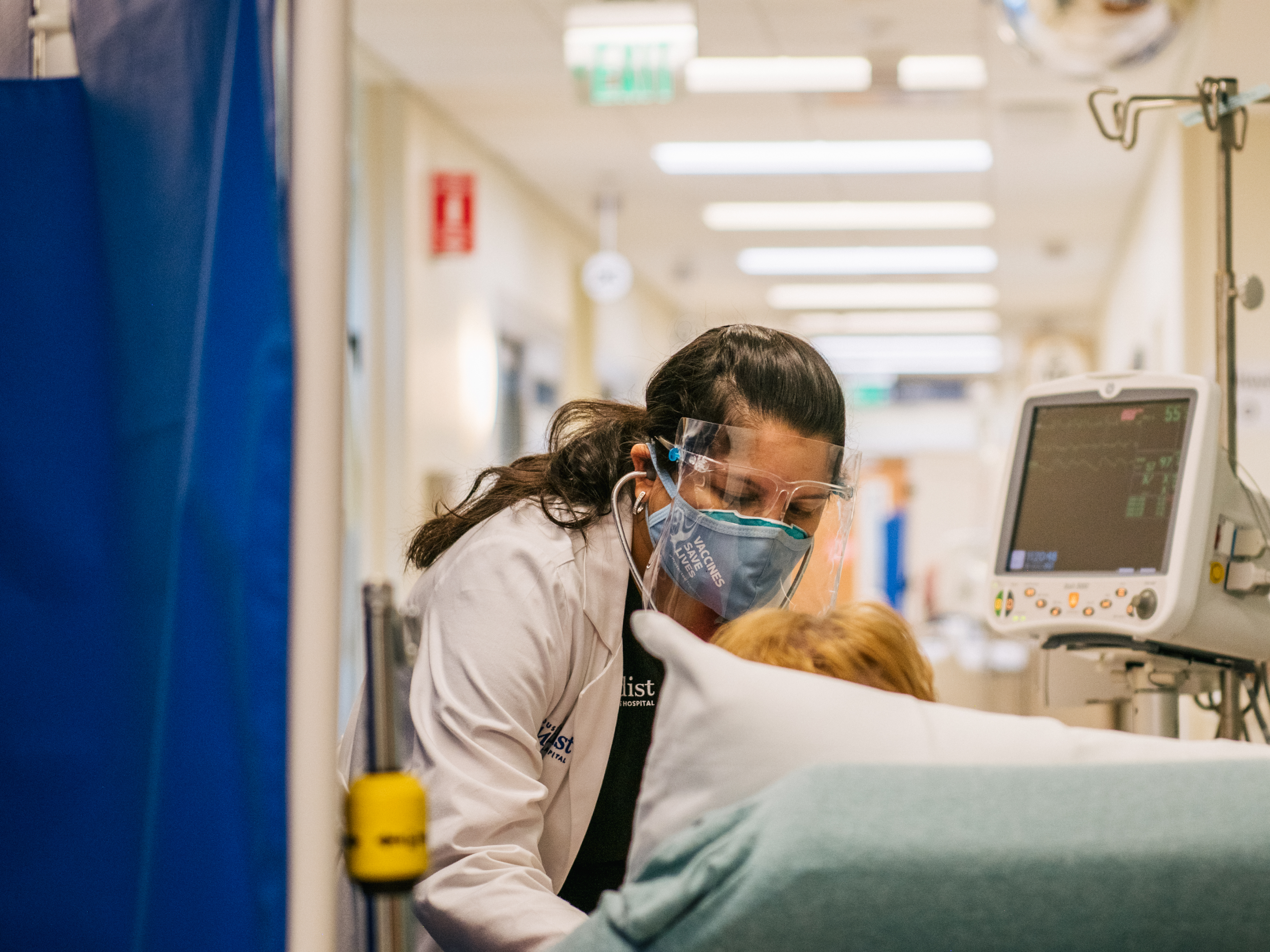 caption: An emergency room nurse tends to a patient in a hallway at the Houston Methodist The Woodlands Hospital on Aug. 18 in Houston.
