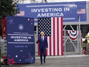 caption: President Biden toured semiconductor manufacturer Wolfspeed Inc. in Durham, N.C., on March 28, 2023 — one of many places where he has touted his industrial policy strategy.