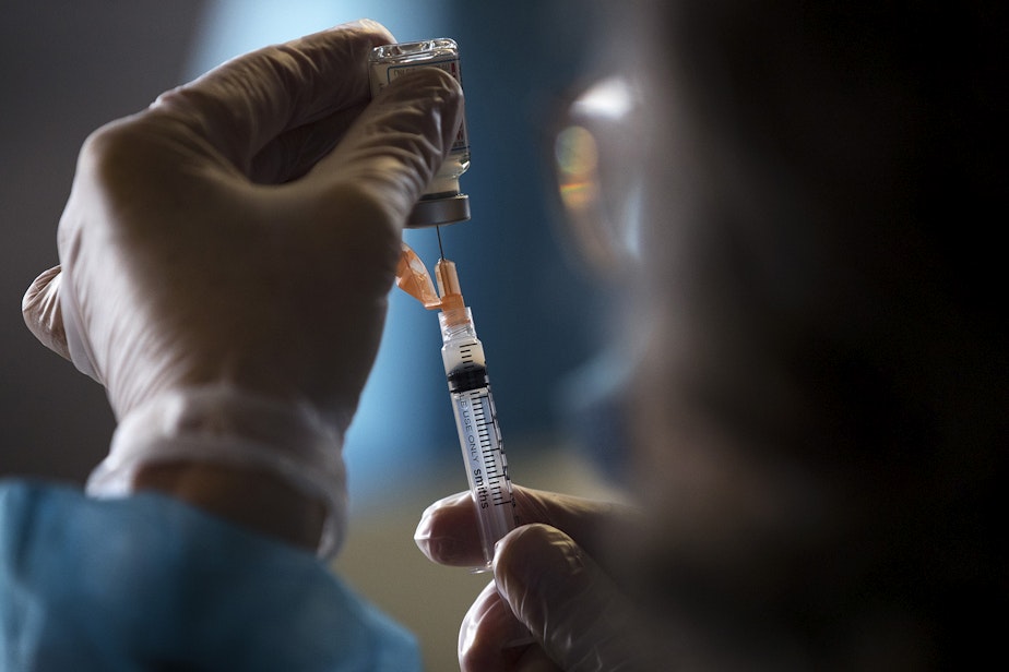 caption: Doses of the Moderna Covid-19 vaccine are drawn out during a vaccine clinic set up by the Othello Station Pharmacy and the Somali Health Board to vaccinate roughly 100 seniors in the community on Wednesday, February 3, 2021, at The Brighton Apartments, a complex for seniors, on Rainier Avenue South in Seattle.