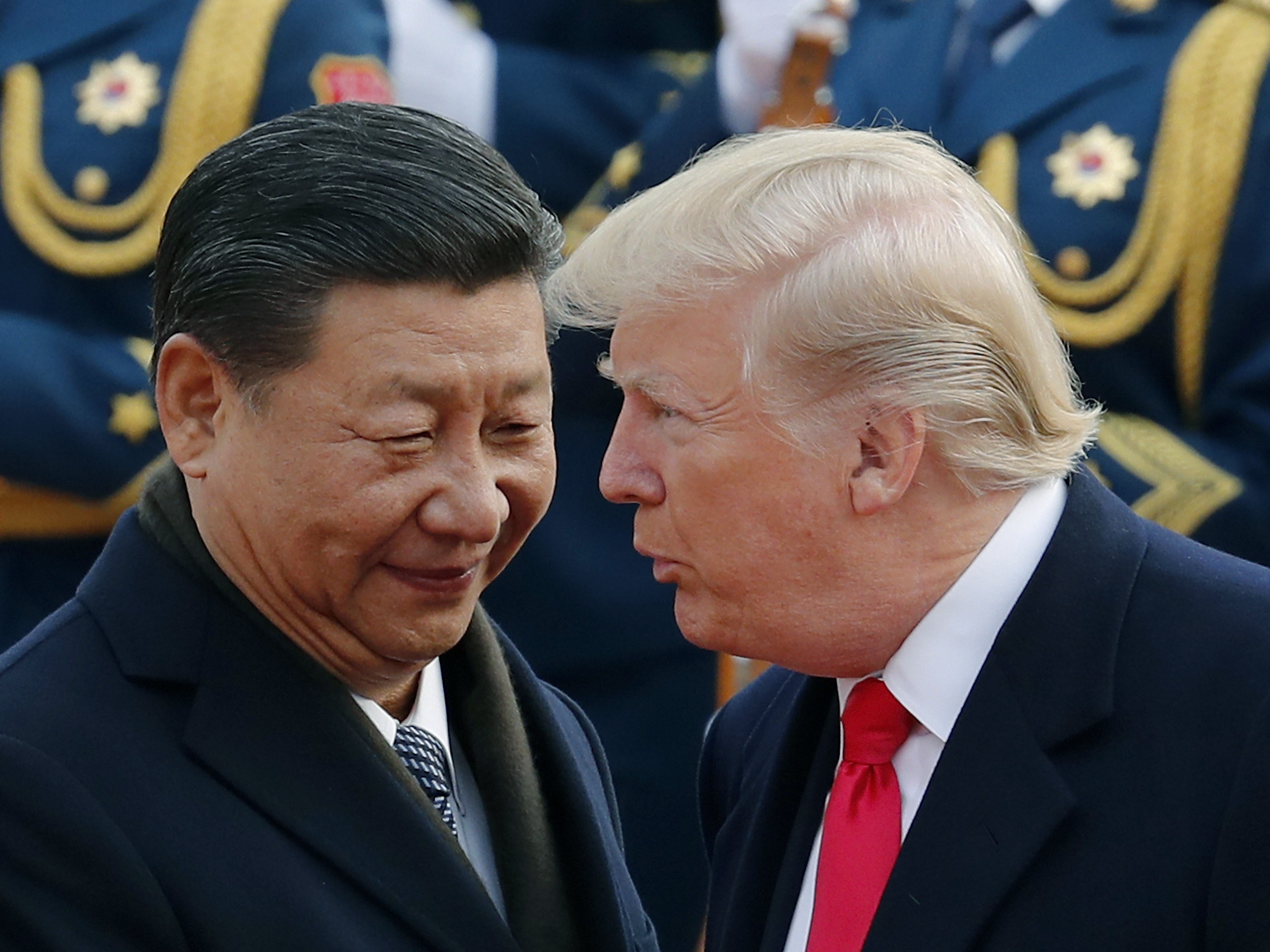 caption: President Trump chats with Chinese President Xi Jinping during a visit to Beijing in 2017.