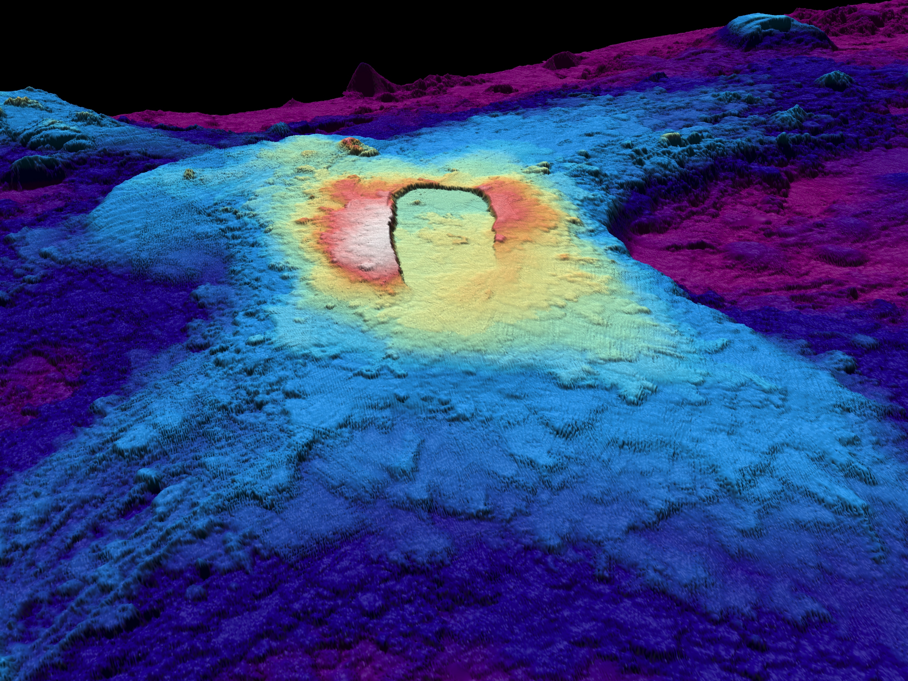 caption: A three-dimensional map of the seabed shows the shape of the caldera of the Axial Seamount volcano. Warm colors show shallower depths and cool colors are deeper.