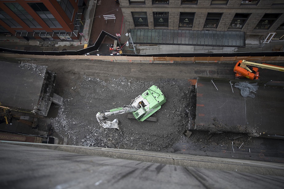 caption: A portion of the Alaskan Way Viaduct is demolished on Monday, February 18, 2019, at the Columbia St. on ramp near the intersection of Columbia Street and 1st Avenue in Seattle. 1.4 miles of the roadway, weighing roughly 122,000 tons, will be demolished. 
