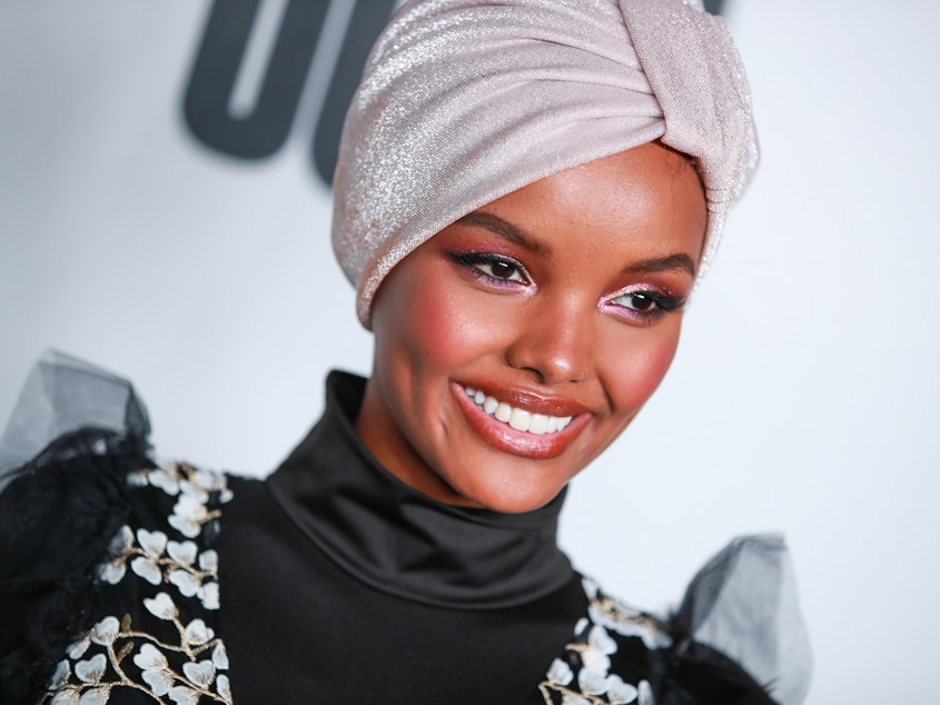 caption: Somali American and Muslim model Halima Aden wears a burkini for <em>Sports Illustrated</em>'s swimsuit issue, sparking both praise and critique on social media.