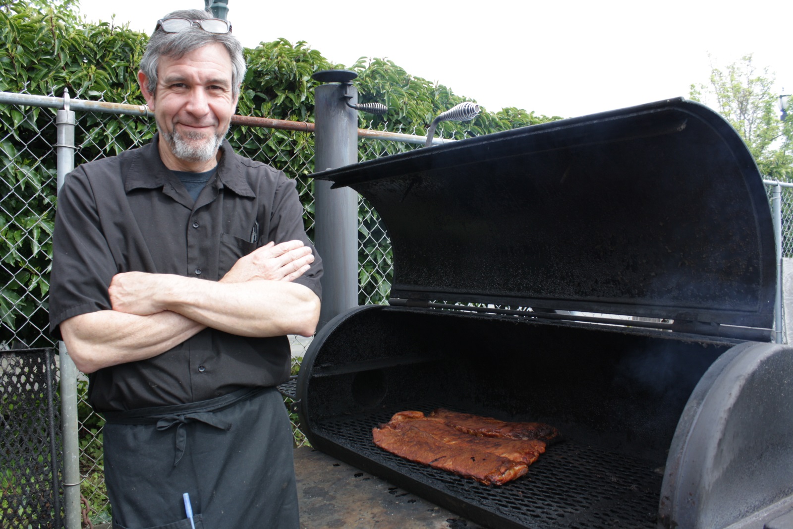 caption: Gilbert Ruiz of the Depot Cafe and Smokehouse. He could throw a brisket and hit the future light rail station in downtown Everett.