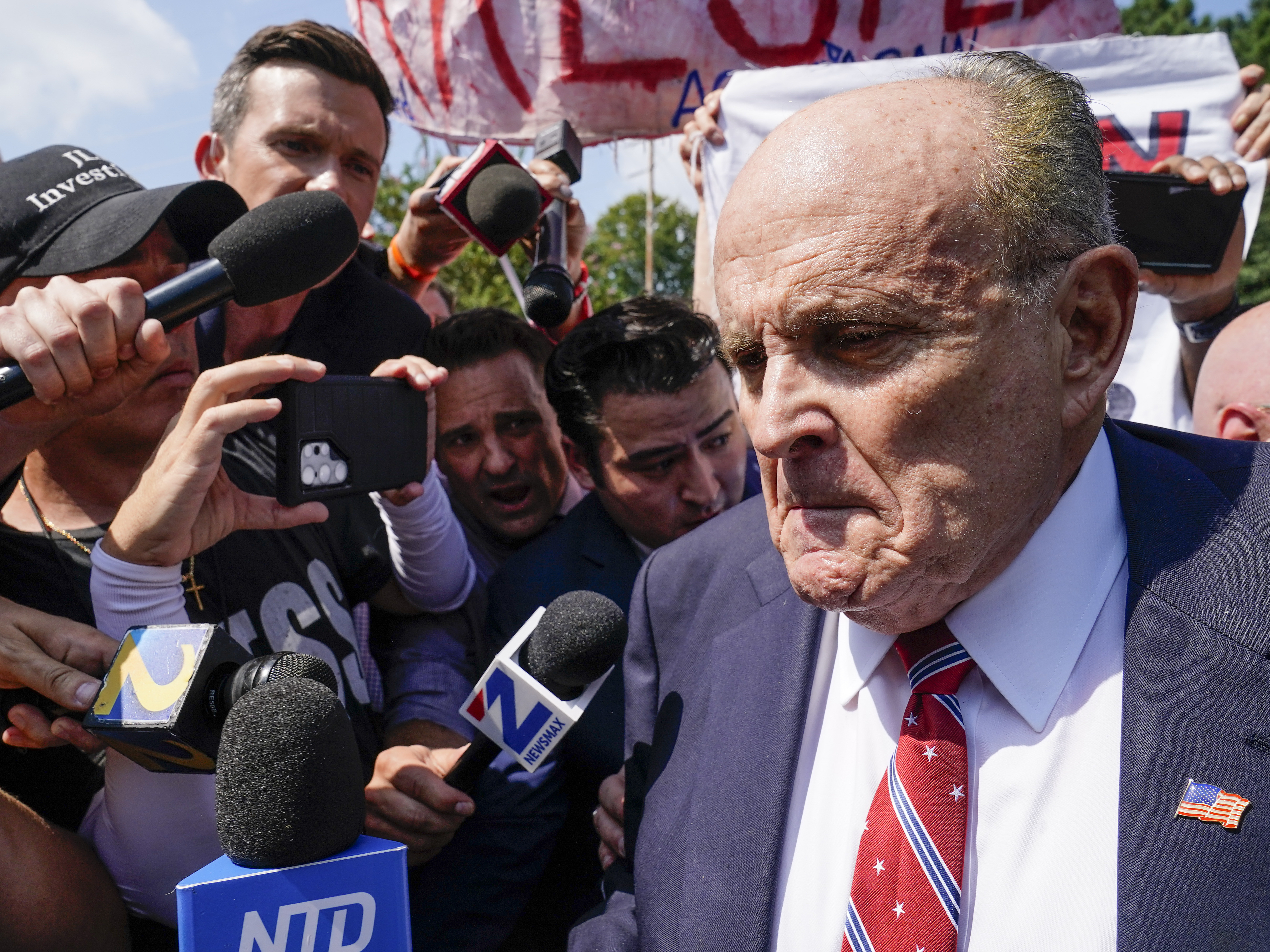 caption: Rudy Giuliani speaks outside the Fulton County jail Aug. 23, in Atlanta. On Friday, he pleaded not guilty to charges that accuse him of trying to illegally overturn the results of the 2020 election in the state.