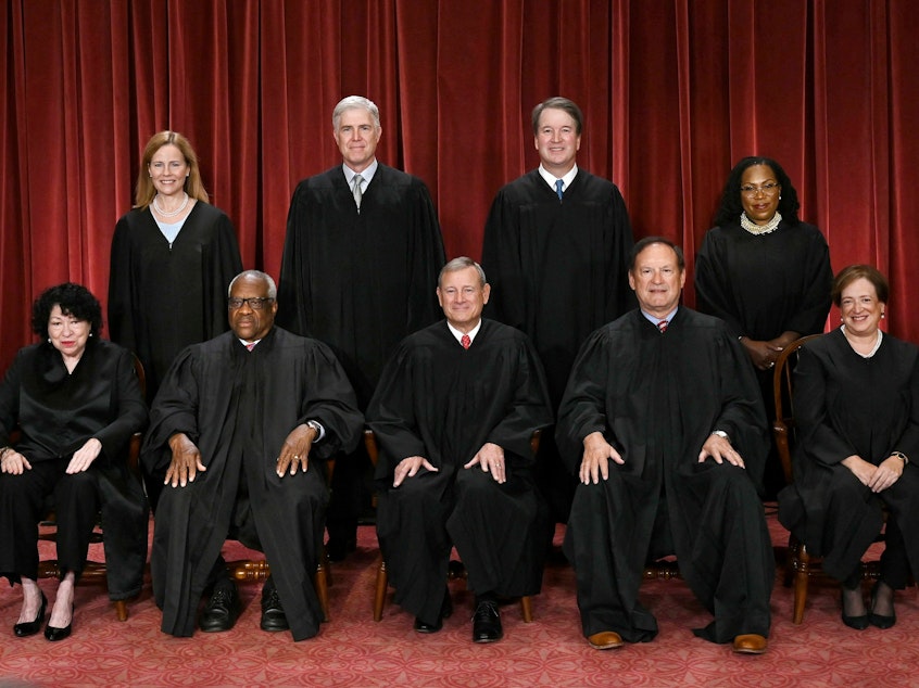 caption: Of the nine justices of the U.S. Supreme Court, only Justice Clarence Thomas (seated second from left) and Justice Samuel Alito (seated fourth from left) did not file their financial disclosures. They asked for — and were granted — extensions.
