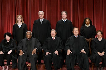 caption: Of the nine justices of the U.S. Supreme Court, only Justice Clarence Thomas (seated second from left) and Justice Samuel Alito (seated fourth from left) did not file their financial disclosures. They asked for — and were granted — extensions.