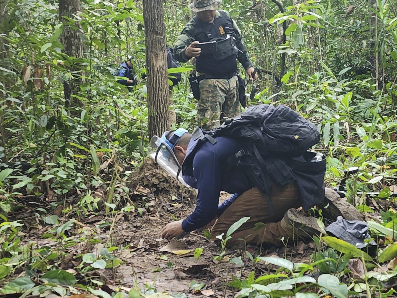 caption: In this July, 2025, photo released by the Royal Thai Army, Thai soldiers inspect a border area in Ubon Ratchathani† province where the Royal Thai Army said two anti-personnel landmines were found.