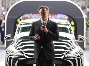 caption: Tesla CEO Elon Musk speaks during the official opening of the new Tesla electric car manufacturing plant near Gruenheide, Germany, on March 22. Tesla shares sank on Tuesday, a day after Twitter accepted a takeover offer from Musk.