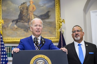 caption: President Biden speaks during a news conference with Miguel Cardona, U.S. secretary of education.