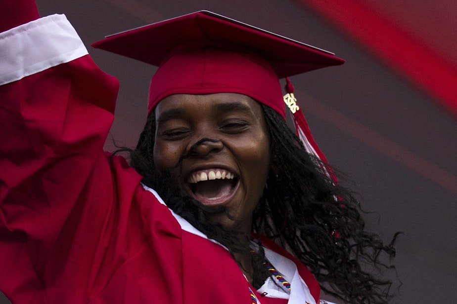 caption: Cleveland Stem High School senior Julia Nuñez Alvarez celebrates after picking up her diploma on Tuesday, June 15, 2021, during an in-person commencement ceremony at Memorial Stadium in Seattle.