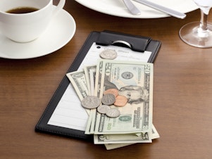 caption: A new rule proposed by the Labor Department would allow employers to require waitstaff and others to share their tips with kitchen staff. But labor advocates say it could allow bosses to take advantage of their workers.