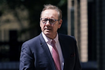caption: Actor Kevin Spacey walks outside Southwark Crown Court in London, Wednesday.