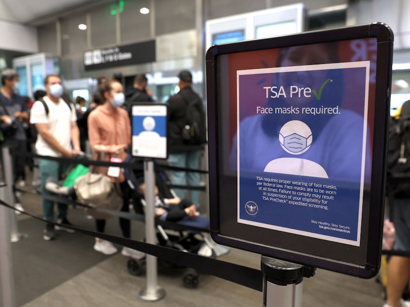 caption: The U.S. Justice Department filed a brief in federal appeals court Tuesday to overturn a federal judge's decision that declared the government mask mandate on planes, trains and buses unlawful. Here, a sign stating that masks are required at San Francisco International Airport stands in a terminal after the federal mask mandate was overturned.