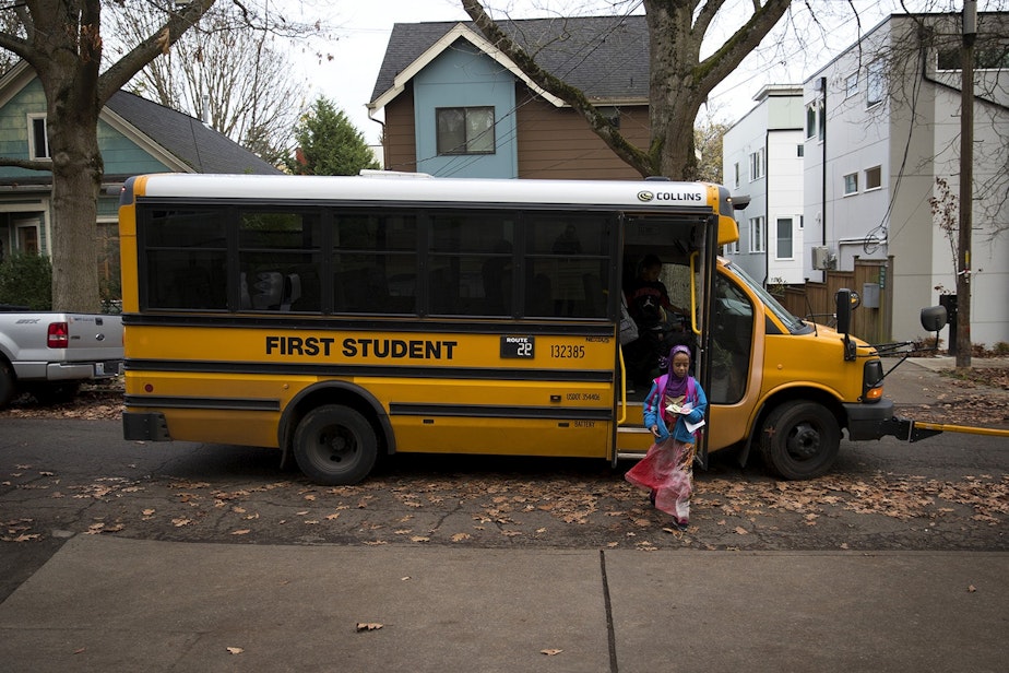 caption: File photo: Biftu Aliya, 9, gets off of the school bus on Thursday, November 15, 2018, at her home in Seattle.
