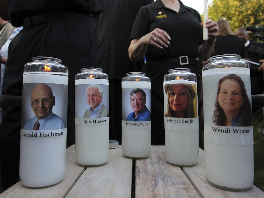 caption: The photos of five people, who were slain in the Capital Gazette newsroom last year, adorn candles at a vigil in June. On Thursday, Reporters Without Borders ranked the U.S. no. 48 in its World Press Freedom Index, citing attacks and threats.