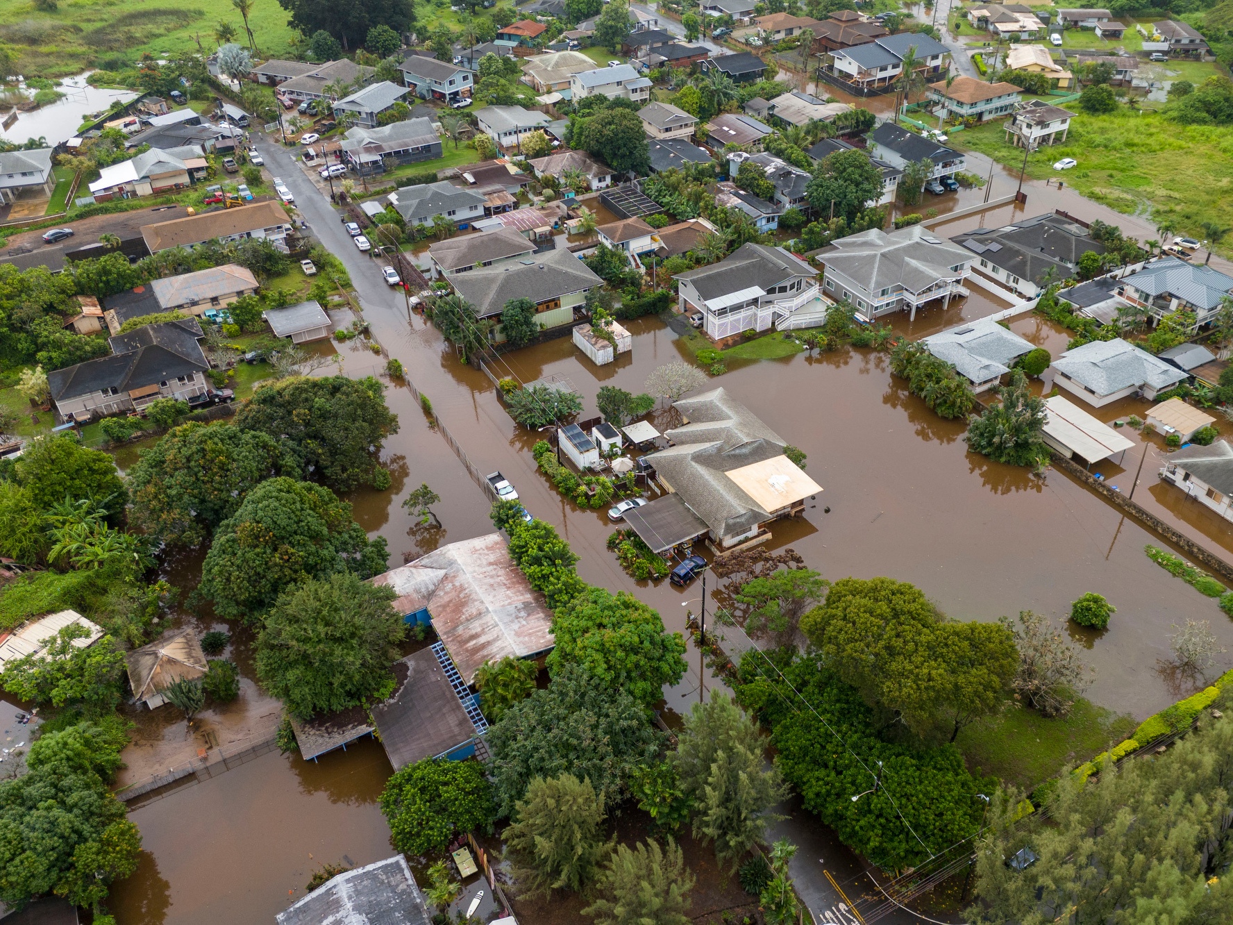 caption: Streets are flooded from severe rains Friday in Haleiwa, Hawaii.