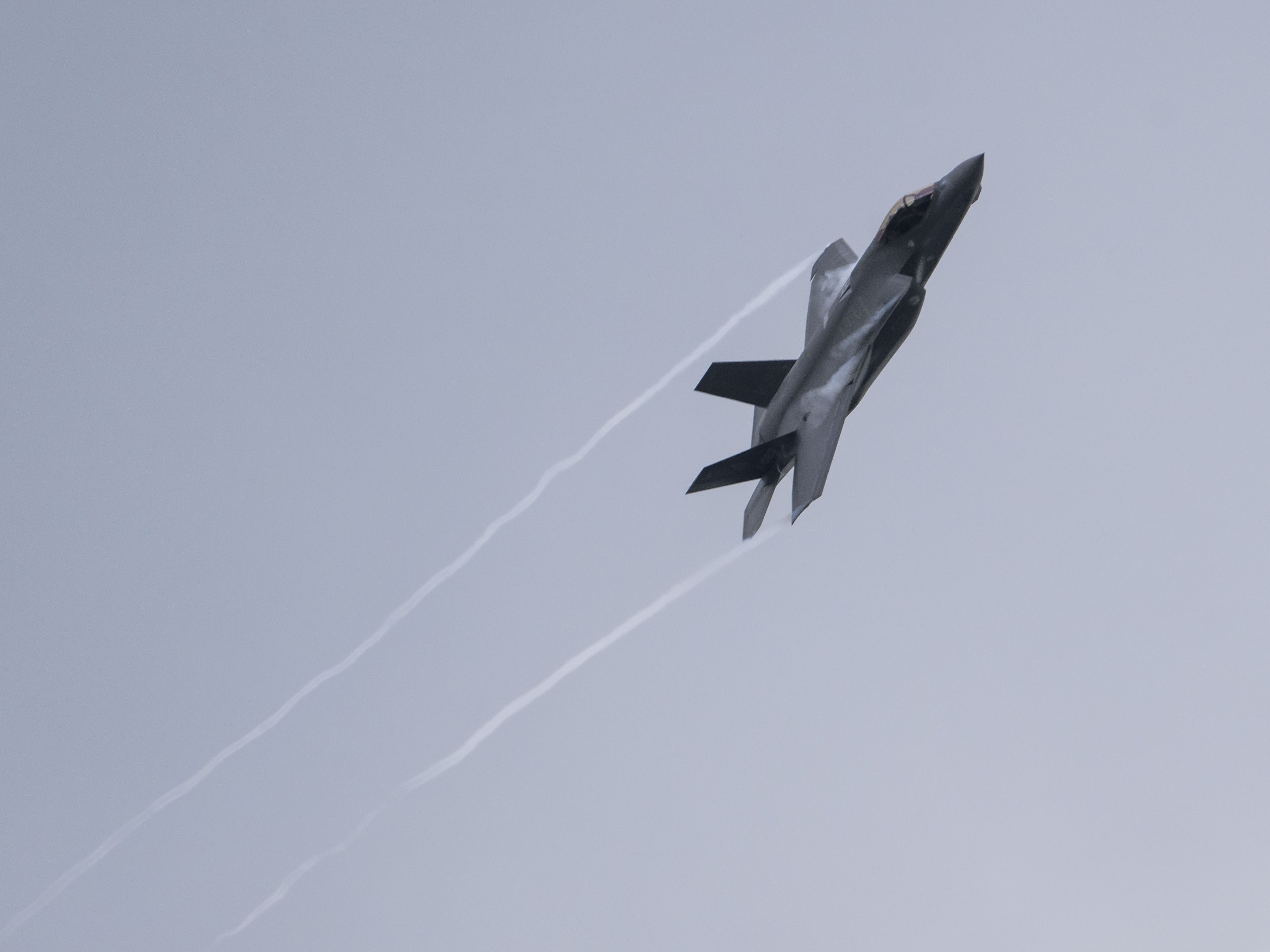 caption: A U.S. Air Force F-35 Lightning II multi-role combat airplane flies over Ramstein Air Base during a day of fighter plane exercises on June 6, 2024, in Ramstein-Miesenbach, Germany.