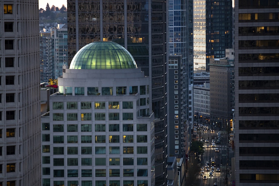 caption: A view of downtown Seattle is shown from the Smith Tower Observatory as the sun sets on Friday, April 12, 2024. 