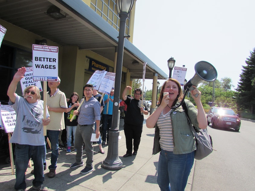 caption: This week Seattle City Council candidate Emily Myers joined informational picketing by supermarket employees with UFCW Local 21.