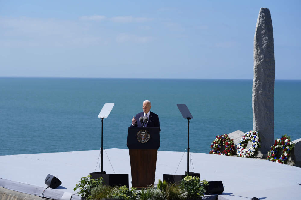 caption: President Joe Biden delivers a speech on the legacy of Pointe du Hoc, and democracy around the world, Friday, June 7, 2024 as he stands next to the Pointe du Hoc monument in Normandy, France. (Evan Vucci/AP)